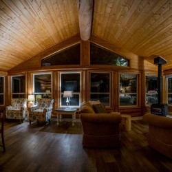 Relax by the fireplace in the guest lounge at Whitewater Lodge in Golden BC