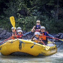 family splashing and rafting kicking horse river