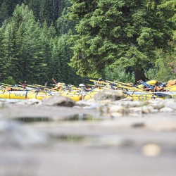 rafts sitting beside kicking horse river waiting to go rafting
