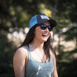 girl wearing a glacier raft company golden bc branded hat and tank top