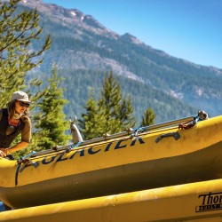 guide loading cat raft onto bus after rafting in golden bc
