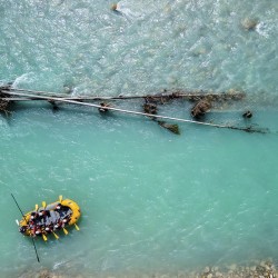 raft floating past tree on kicking horse river