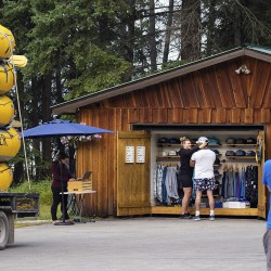 guests trying on hats at glacier raft company base in golden