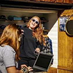 guest purchasing sunglasses at glacier raft company base in golden