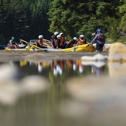 guide chatting with guests before rafting kicking horse river