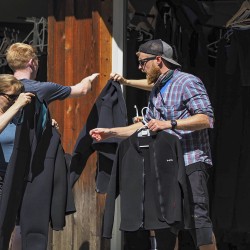 glacier raft company guide handing out wetsuits for kicking horse river rafting