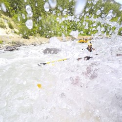 splashes going over a raft on the kicking horse river