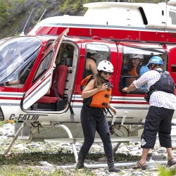 girl getting out of helicopter at kicking horse river