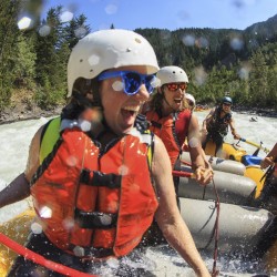 rafters smiling and laughing as they raft down the kicking horse river