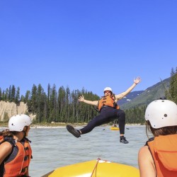 guest jumping into the kicking horse river to go for a swim