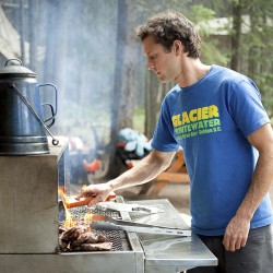 chef cooking lunch beside kicking horse river for a riverside BBQ