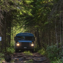 glacier raft company bus driving towards kicking horse river