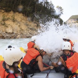 big rapid hits guests in a raft on kicking horse river