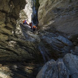 3 kids hiking up waterfall beside kicking horse river