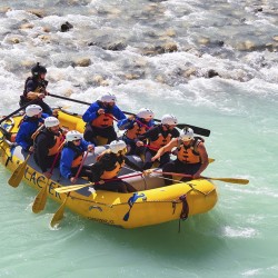guests rafting bright blue glacial water of kicking horse river