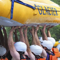 guests loading glacier raft company boat onto truck