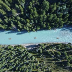 aerial view of 3 glacier raft company rafts on kicking horse river