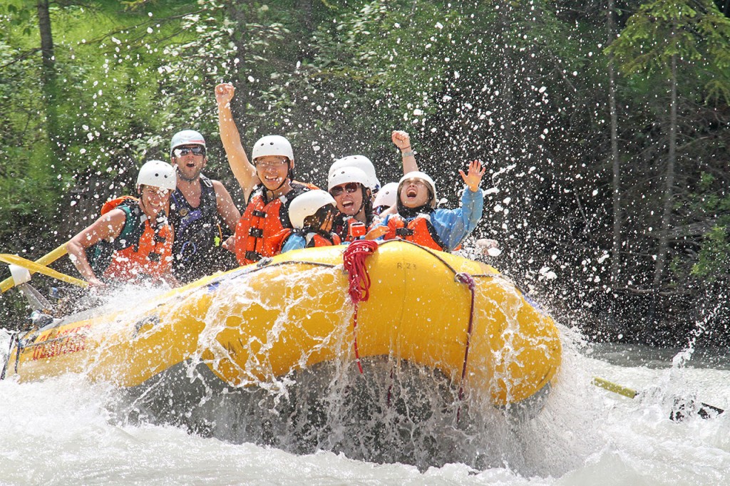 Kids laughing while family rafting the Kicking Horse River