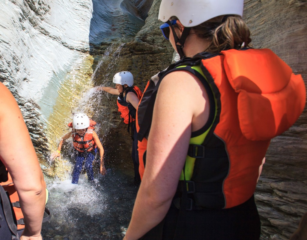 Children playing in a waterfall on their Kicking Horse rafting trip