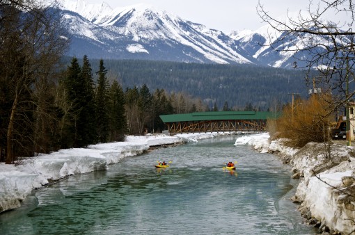 Kayaking towards the Timber Frame Pedestrian Bridge in Golden, British Columbia