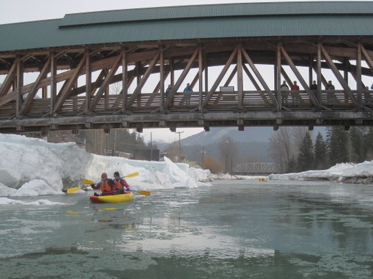 Kayaking underneath the Timber Frame Pedestrian Bridge in Golden British Columbia