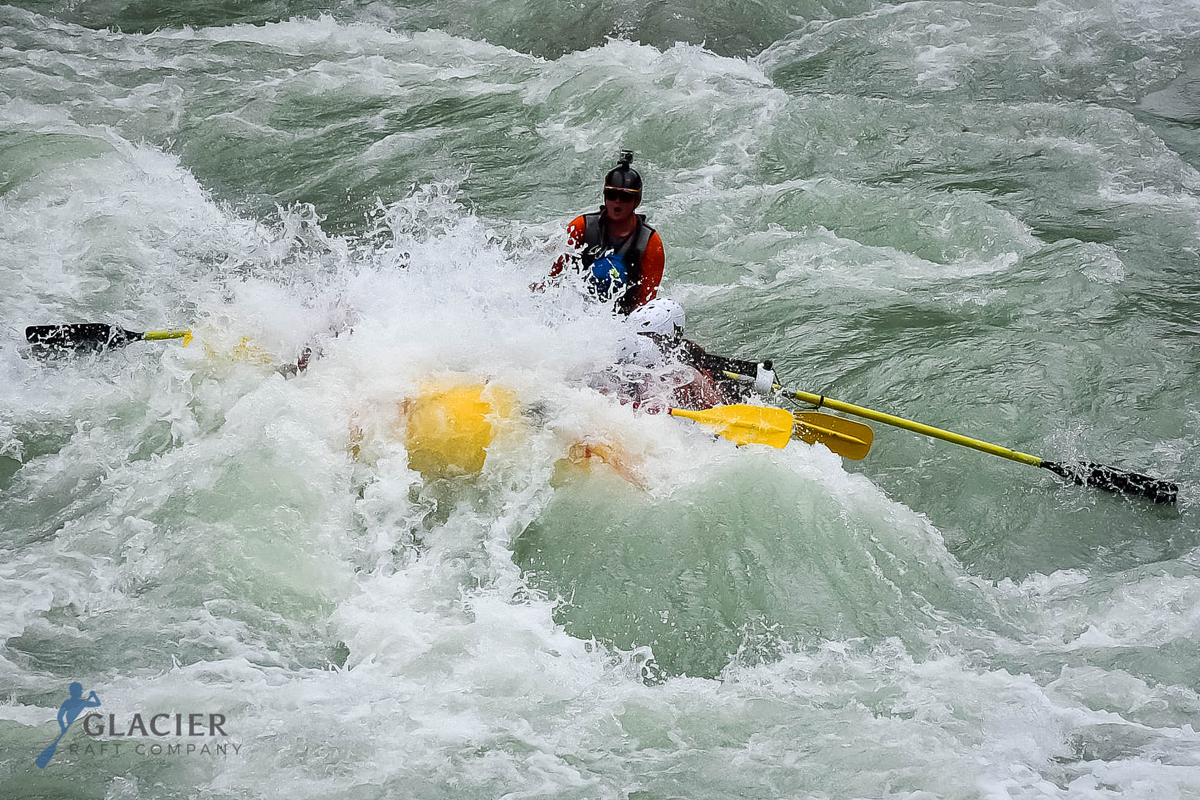 boat going through a big rapid on the Kicking Horse River