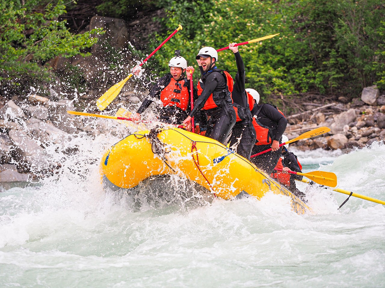 A group of guys river rafting in Golden BC on Kicking Horse