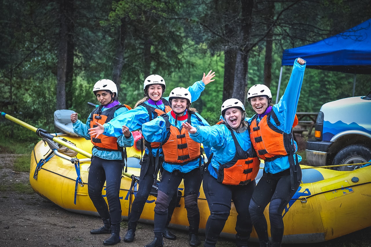 group of girlfriends celebrating their rafting trip on kicking horse river