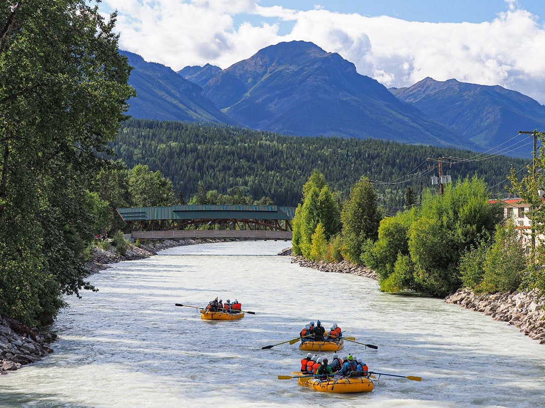 3 boats rafting kicking horse through town of golden bc
