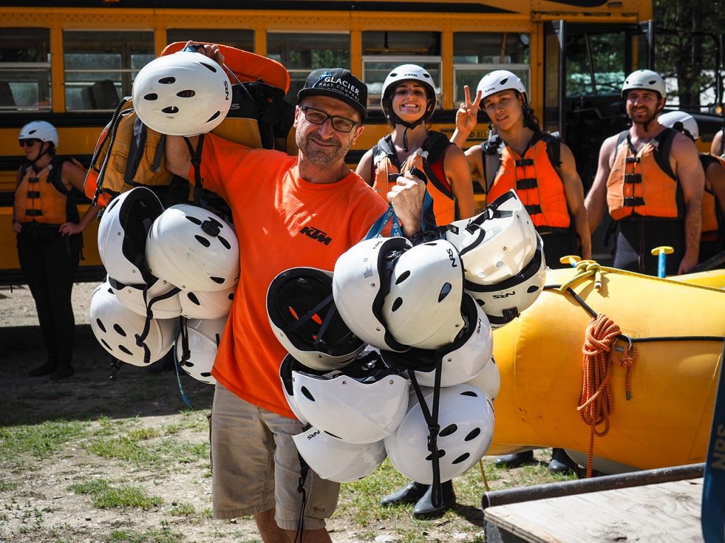 Glacier staff and guests getting helmets before going rafting