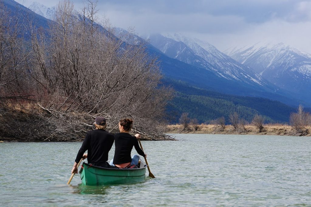 2 people paddling a canoe on Columbia River in Columbia Wetlands