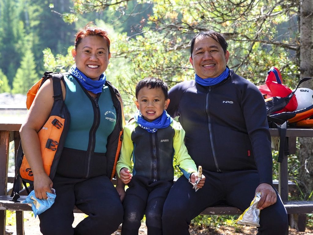 A family spending day together rafting - one benefit of spending time outside with your kids