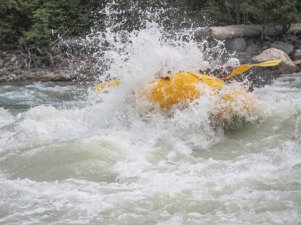Big splashes while rafting the Kicking Horse River on a rainy day