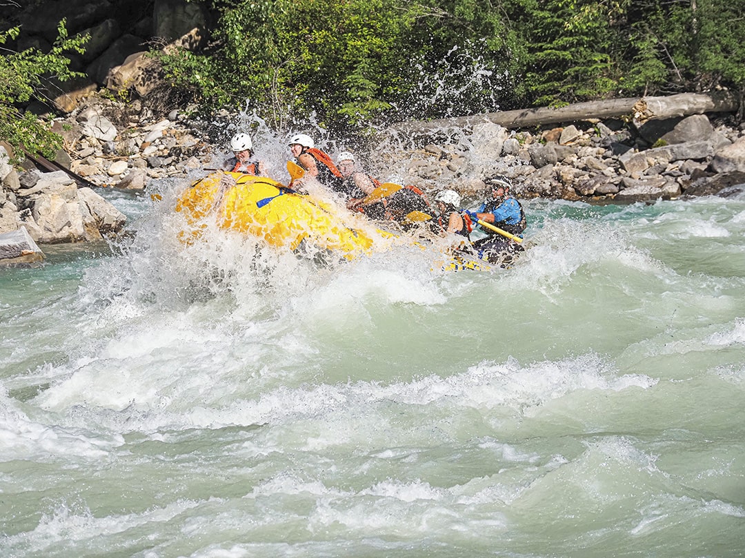 big splash going over a raft on the kicking horse river